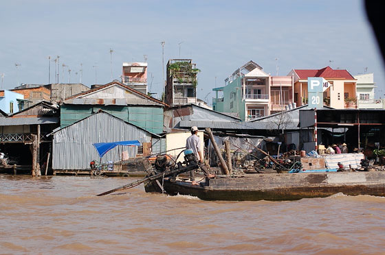 DELTA DEL MEKONG - E' mattina presto e la luce riflette sulle acque melmose del Mekong